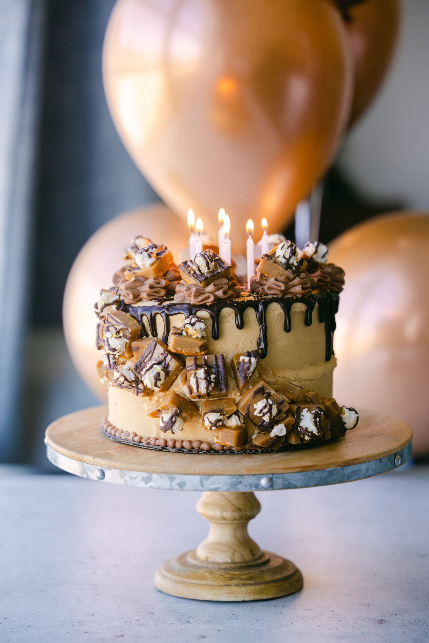 Case Study: Cache Toffee Collection Party Photoshoot | Elle Marketing and Events | Cake with candles, toffee, and balloons