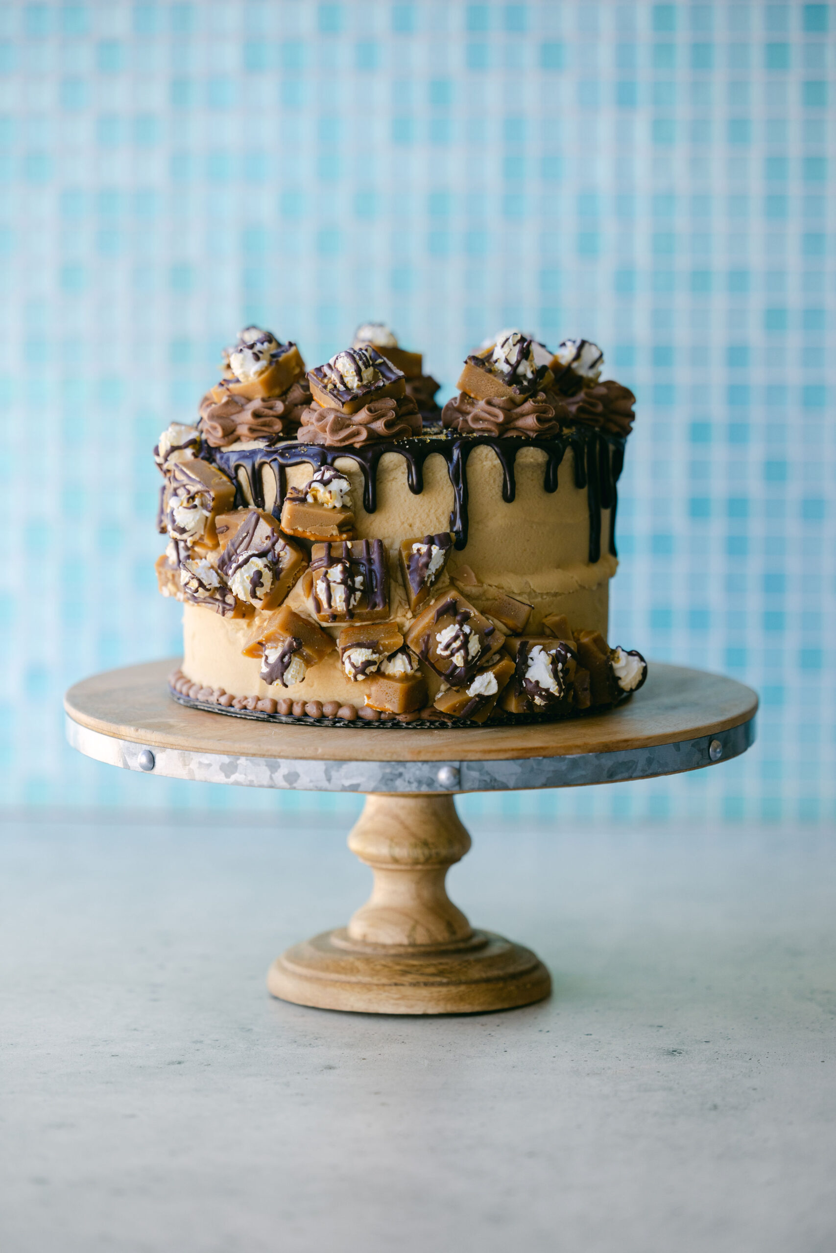 Case Study: Cache Toffee Collection Party Photoshoot | Elle Marketing and Events | Toffee Cake on a blue background