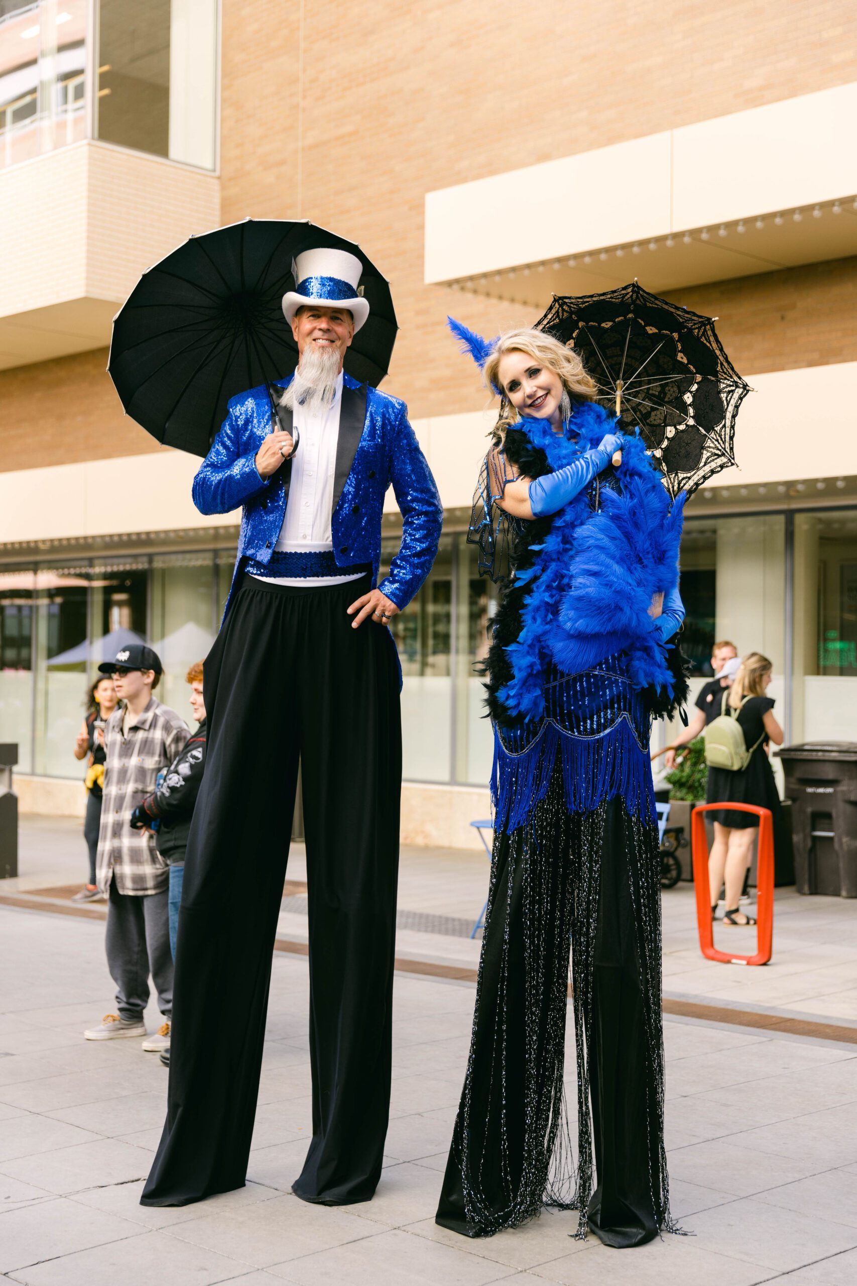 Case Study: SLC Busker Fest Event Photography & Event Marketing by Elle Marketing and Events | Couple on stilts