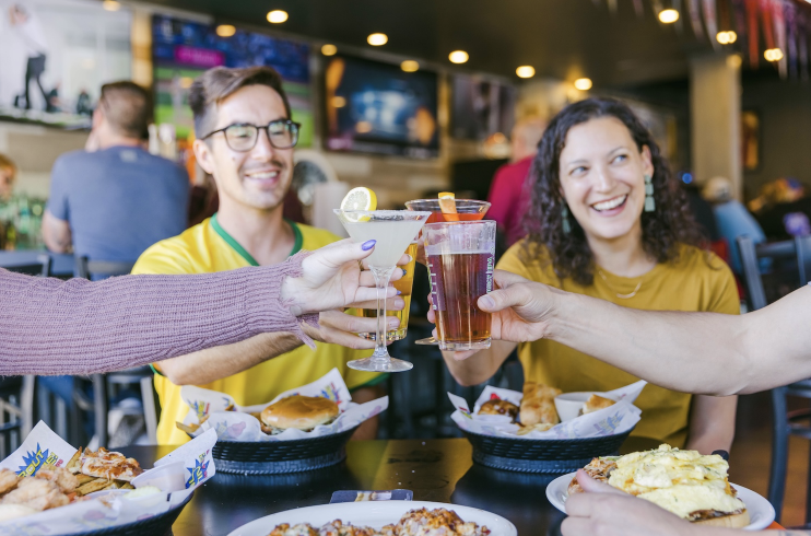bout-time-guests-cheering-with-drinks-thanksgiving-weekend