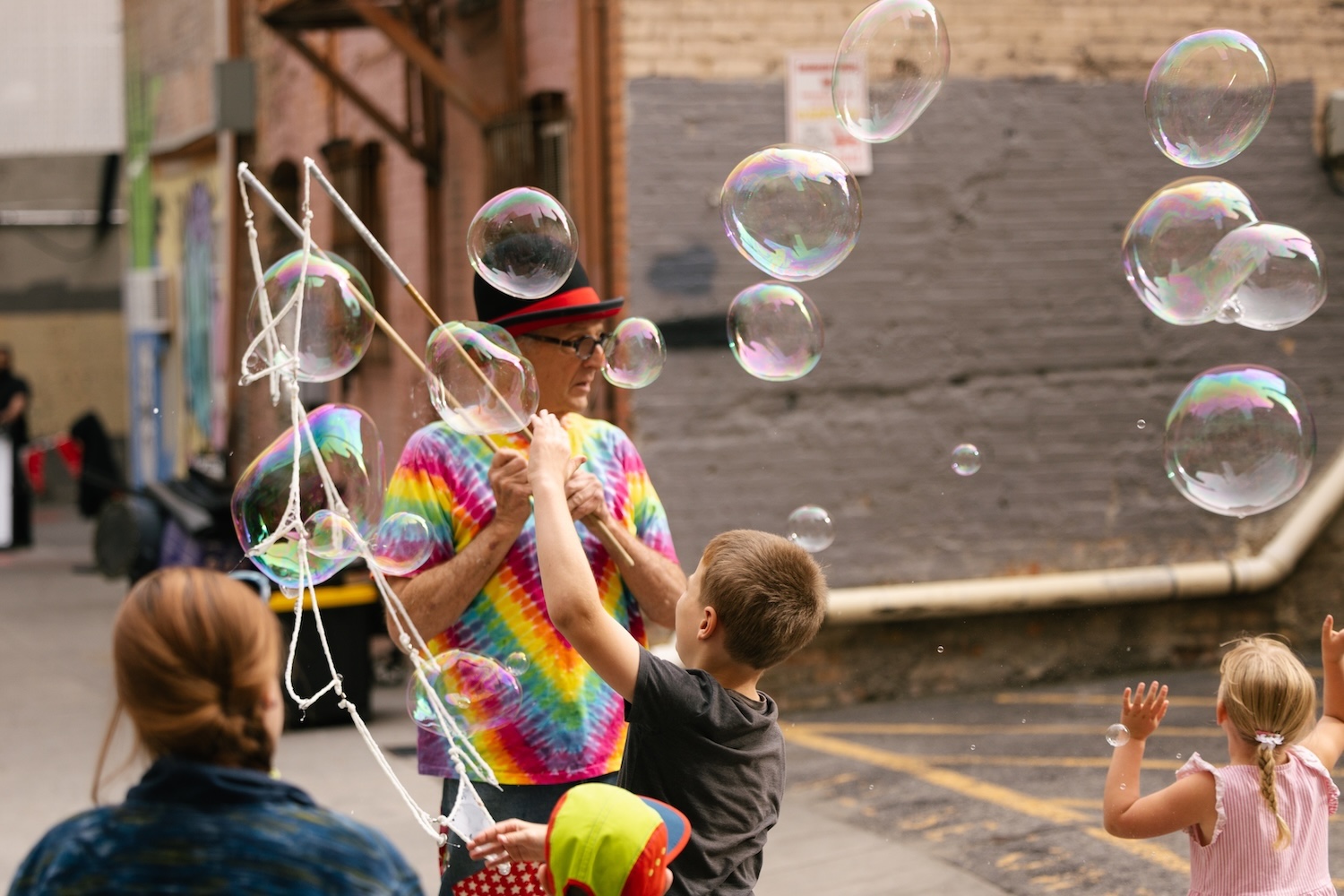 Children enjoying a bubble performance during Busker Fest SLC in downtown Salt Lake City