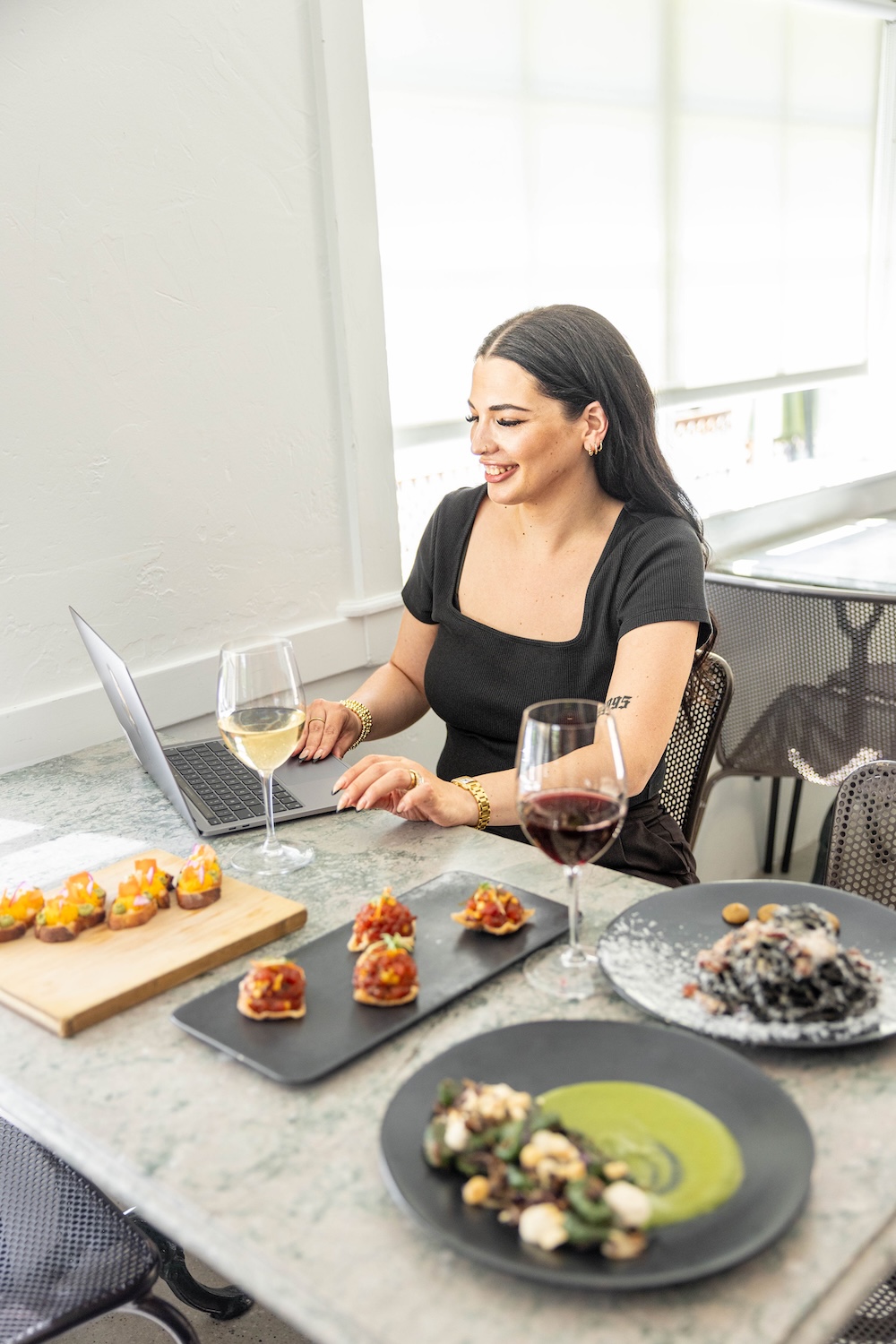 Elle Marketing Social Media Manager Michaela Wiblin working behind the scenes at a Cucina Wine Bar photoshoot.