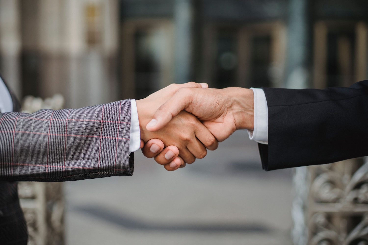 Two business professionals shaking hands to symbolize a professional partnership.
